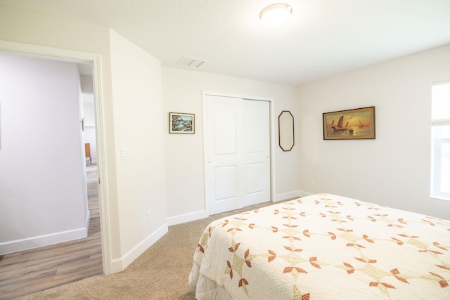 carpeted bedroom featuring a closet