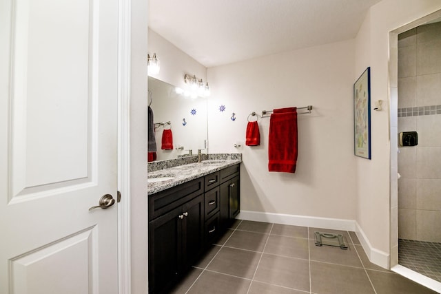 bathroom featuring tile patterned floors, vanity, and tiled shower