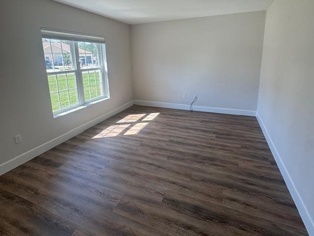 spare room featuring dark wood-type flooring