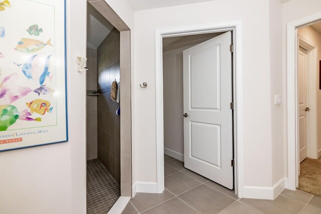 corridor featuring light tile patterned floors