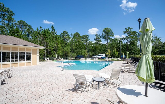 2251 Golden Lake Loop, Saint Augustine, FL 32084 - community pool featuring a patio area and view of scattered trees