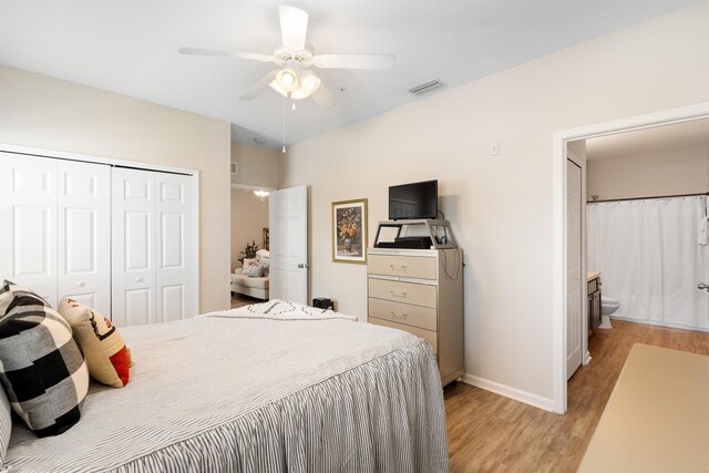 2251 Golden Lake Loop, Saint Augustine, FL 32084 - bedroom featuring light wood-type flooring, a closet, ceiling fan, and ensuite bath