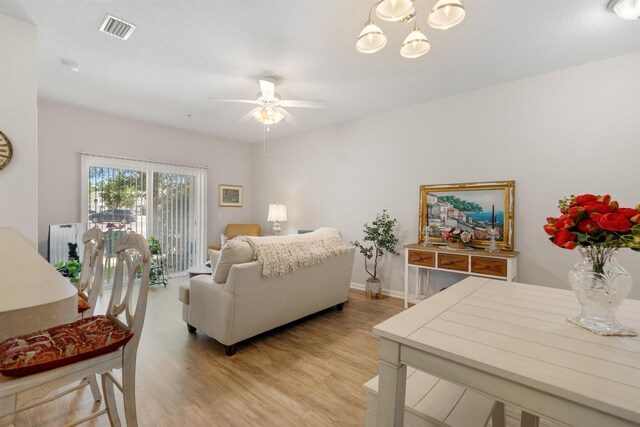 2251 Golden Lake Loop, Saint Augustine, FL 32084 - living area with a ceiling fan, light wood-style floors, and a chandelier