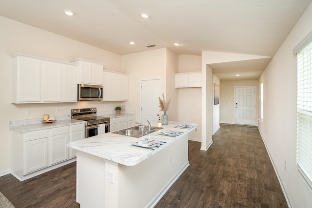 2730 Oak Stream Dr, Green Cove Springs, FL 32043 - kitchen featuring stainless steel appliances, dark wood finished floors, white cabinetry, lofted ceiling, and light countertops