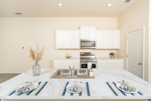 2730 Oak Stream Dr, Green Cove Springs, FL 32043 - kitchen with stainless steel appliances, light stone counters, white cabinets, and recessed lighting