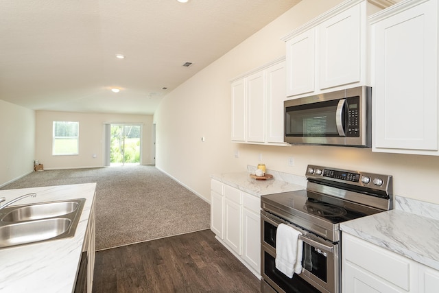 2730 Oak Stream Dr, Green Cove Springs, FL 32043 - kitchen with stainless steel appliances, open floor plan, white cabinetry, dark wood-style flooring, and recessed lighting