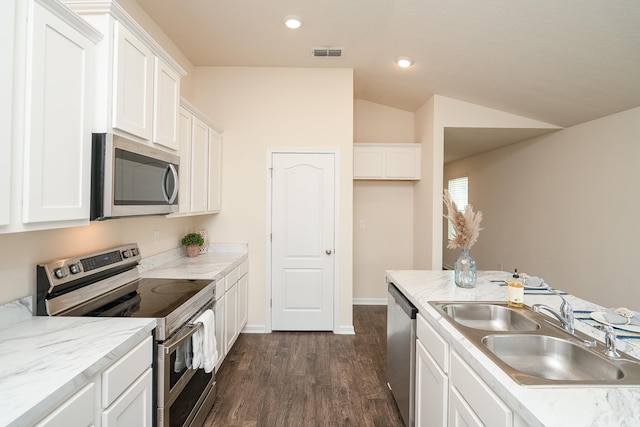 2730 Oak Stream Dr, Green Cove Springs, FL 32043 - kitchen with appliances with stainless steel finishes, dark wood-type flooring, white cabinetry, light countertops, and lofted ceiling