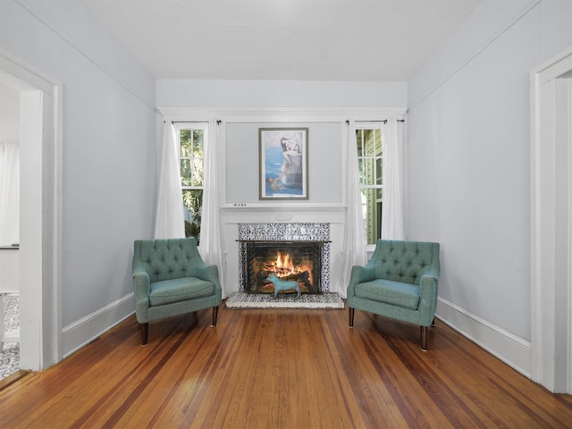 sitting room featuring a fireplace and wood-type flooring