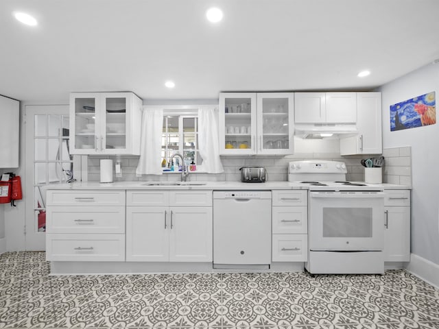 kitchen with white cabinetry, white appliances, and sink