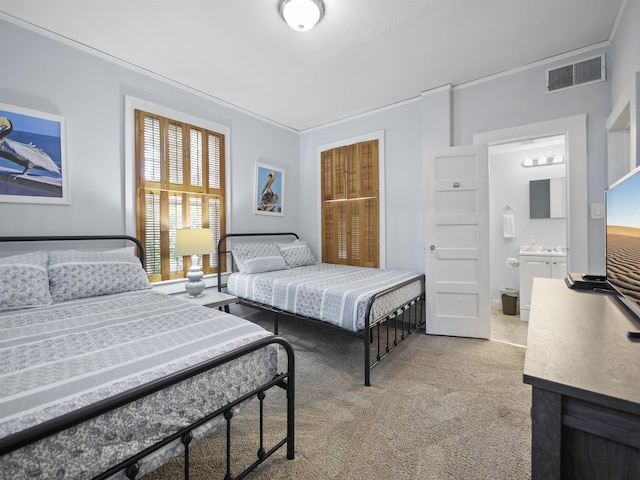 carpeted bedroom with ensuite bathroom