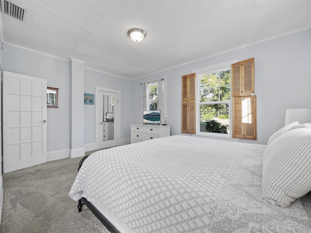 carpeted bedroom with ornamental molding