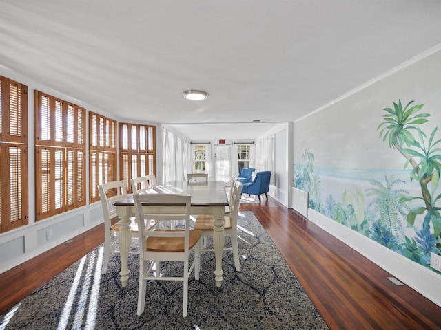 dining space with crown molding and dark hardwood / wood-style flooring