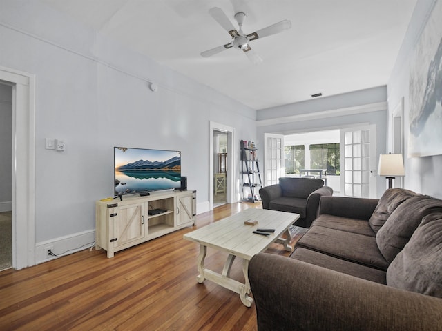 living room featuring hardwood / wood-style flooring and ceiling fan