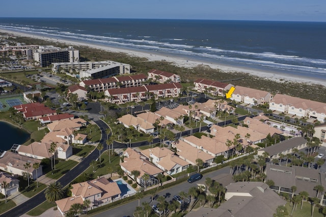 birds eye view of property with a water view and a view of the beach