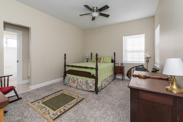 bedroom featuring a textured ceiling, ceiling fan, and light colored carpet