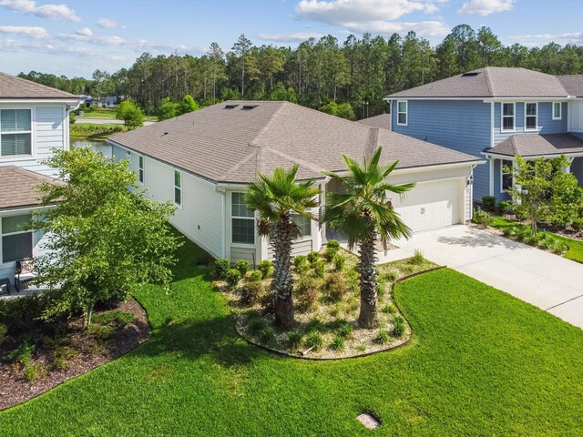 182 Myrtle Oak Ct, Saint Augustine, FL 32092 - view of front of home with a garage, concrete driveway, a front yard, and a shingled roof