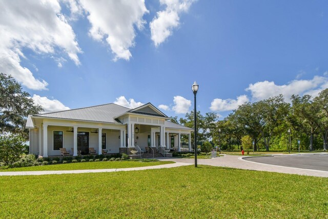 182 Myrtle Oak Ct, Saint Augustine, FL 32092 - greek revival house featuring a porch, a front yard, and metal roof