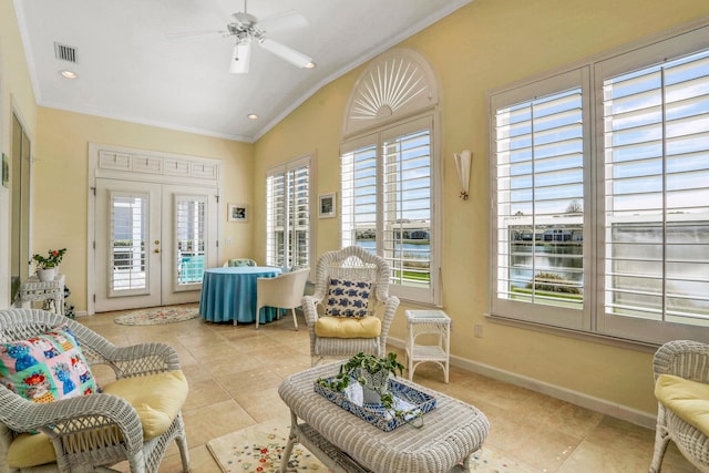 sunroom featuring french doors, visible vents, vaulted ceiling, and ceiling fan