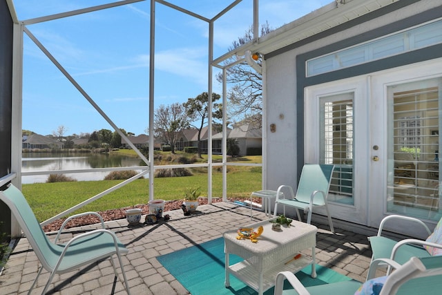 unfurnished sunroom featuring a water view