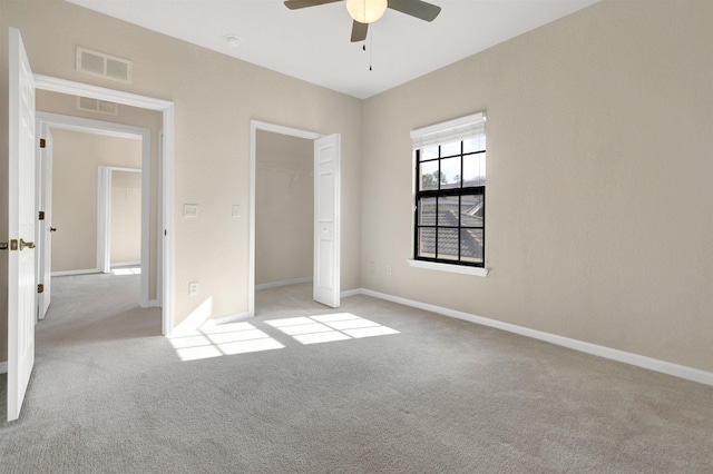 unfurnished bedroom with ceiling fan, a closet, and light carpet