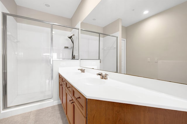 bathroom with tile patterned floors, vanity, and an enclosed shower