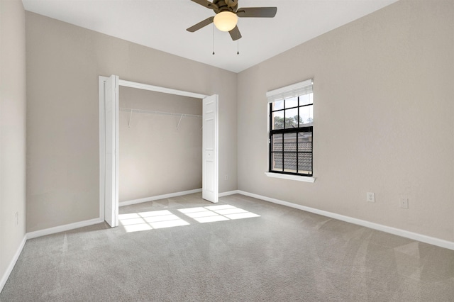 unfurnished bedroom featuring a closet, ceiling fan, and light colored carpet