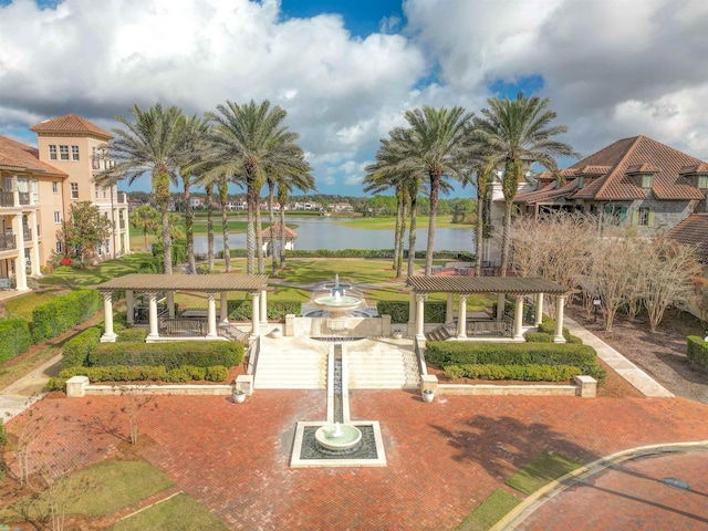 view of home's community featuring a water view and a pergola