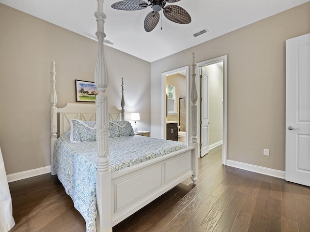 bedroom with ceiling fan, dark wood-type flooring, and connected bathroom