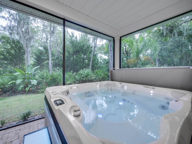 sunroom with a hot tub