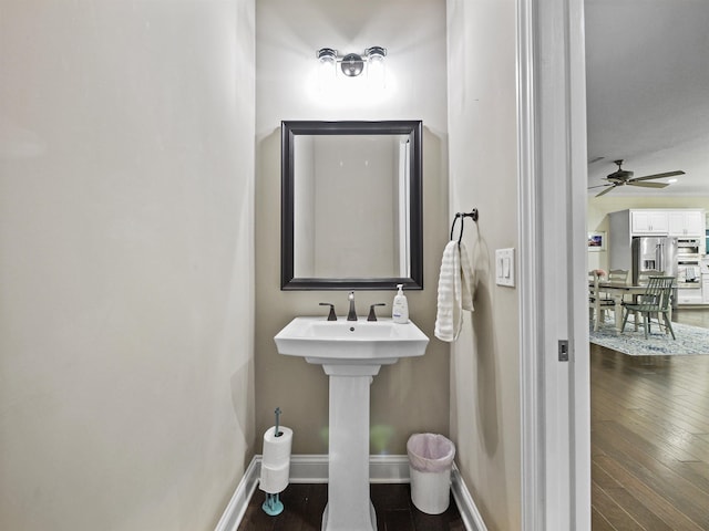 bathroom featuring ceiling fan and wood-type flooring