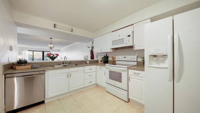 kitchen with pendant lighting, white cabinetry, white appliances, and sink