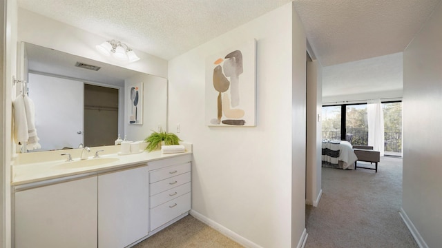 bathroom with vanity and a textured ceiling