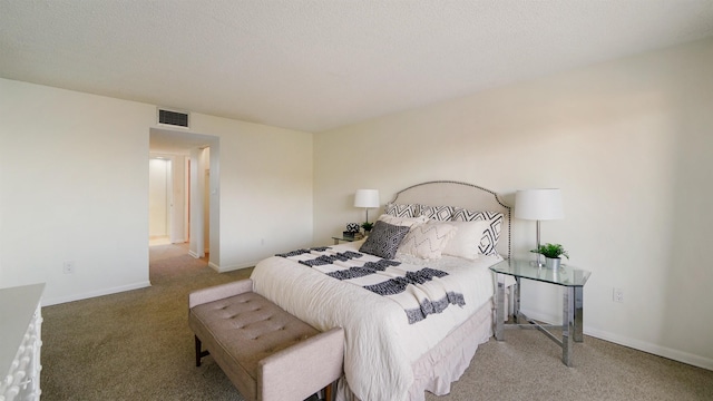 bedroom with carpet and a textured ceiling