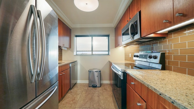 kitchen with backsplash, light stone counters, ornamental molding, stainless steel appliances, and light tile patterned flooring