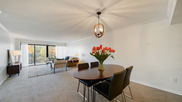 dining room with carpet flooring, a textured ceiling, ornamental molding, and a notable chandelier