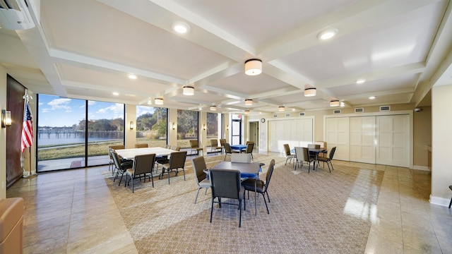 tiled dining room featuring beamed ceiling, a water view, coffered ceiling, and a wall of windows