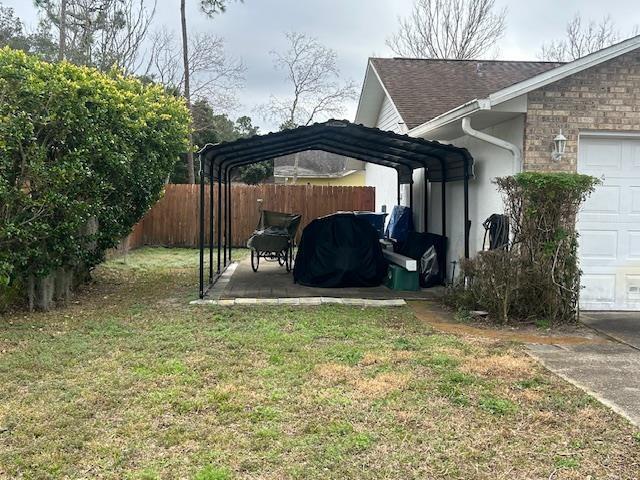 1417 Golf Ave, Ormond Beach, FL 32174 - view of yard with an attached garage and a carport