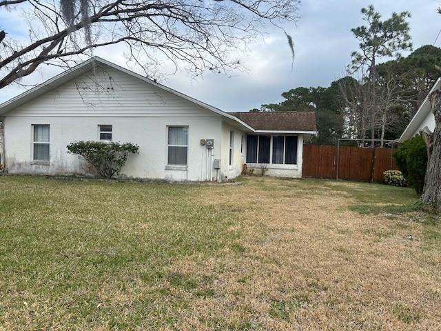 1417 Golf Ave, Ormond Beach, FL 32174 - back of property featuring stucco siding and a sunroom