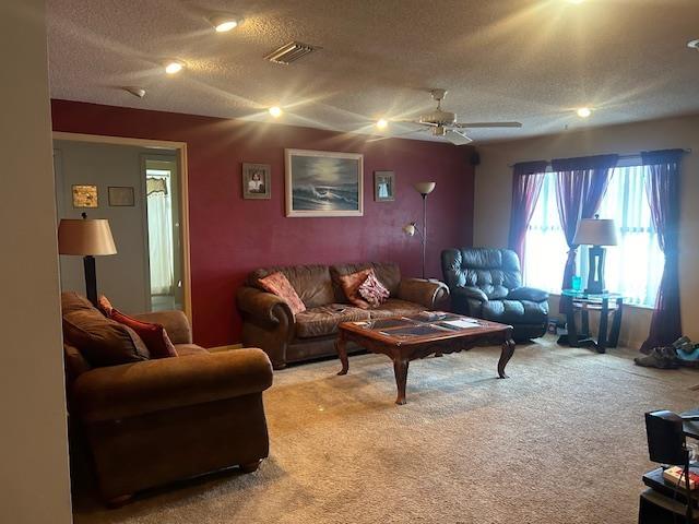 1417 Golf Ave, Ormond Beach, FL 32174 - carpeted living room featuring a textured ceiling and a ceiling fan