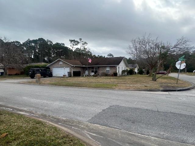 1417 Golf Ave, Ormond Beach, FL 32174 - view of asphalt street featuring traffic signs and curbs