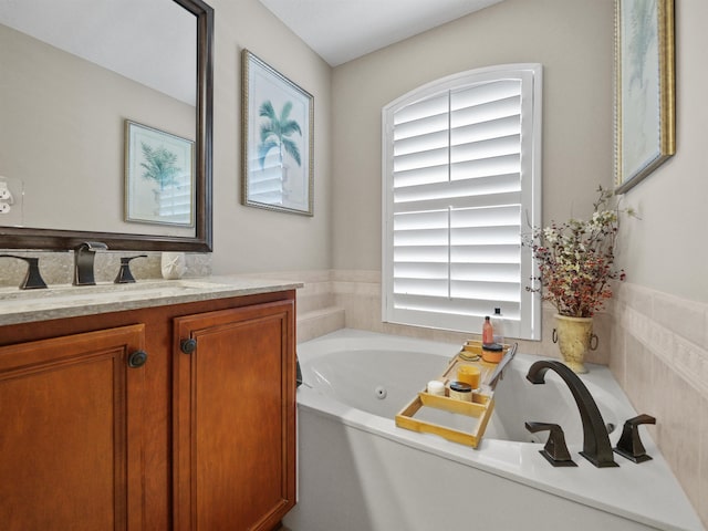 bathroom with vanity and a bath