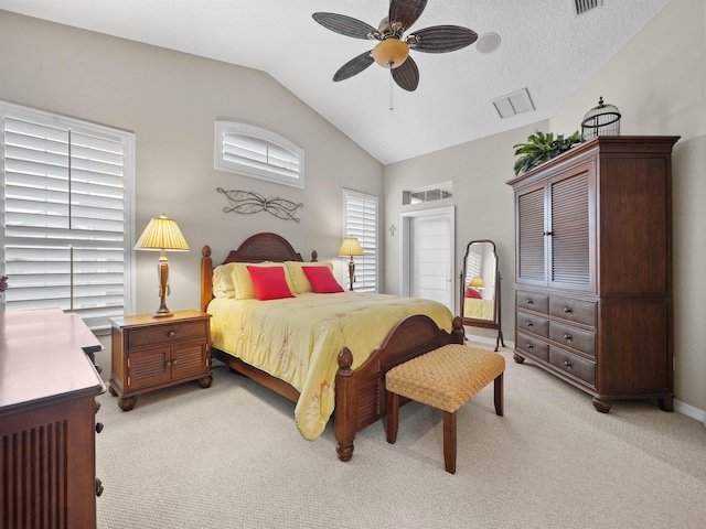 bedroom with a textured ceiling, ceiling fan, light carpet, and vaulted ceiling