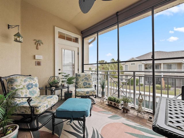 sunroom featuring ceiling fan