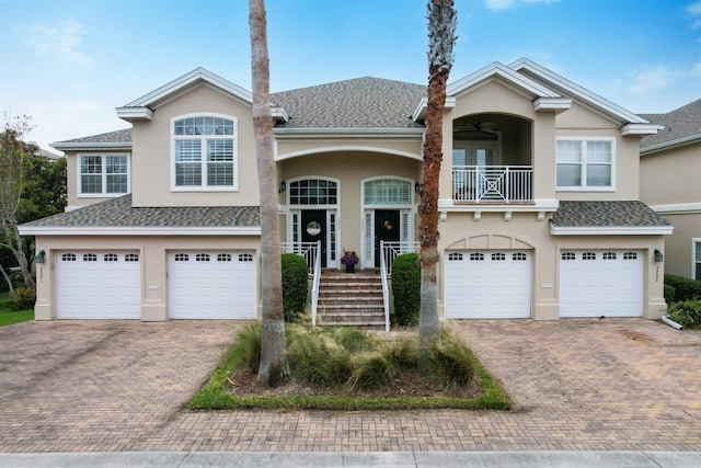 view of front facade with a garage and a balcony