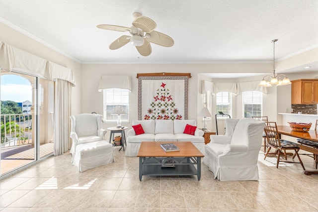 tiled living room featuring ceiling fan with notable chandelier, crown molding, and a wealth of natural light