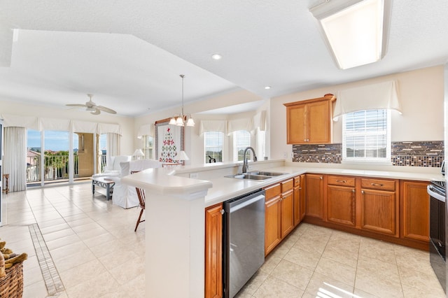 kitchen featuring sink, a healthy amount of sunlight, tasteful backsplash, kitchen peninsula, and appliances with stainless steel finishes