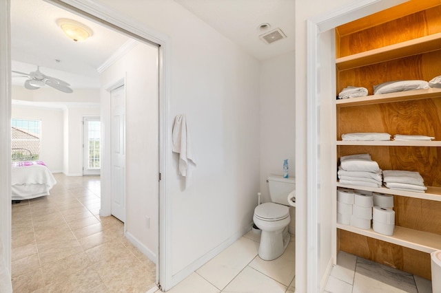 bathroom with tile patterned floors, toilet, ceiling fan, and ornamental molding