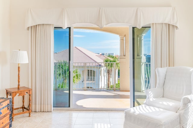 doorway with a water view and light tile patterned floors