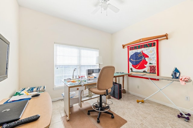 home office with a wealth of natural light, ceiling fan, and light tile patterned floors