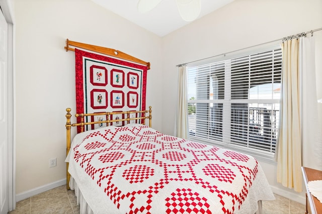 bedroom with ceiling fan and light tile patterned flooring